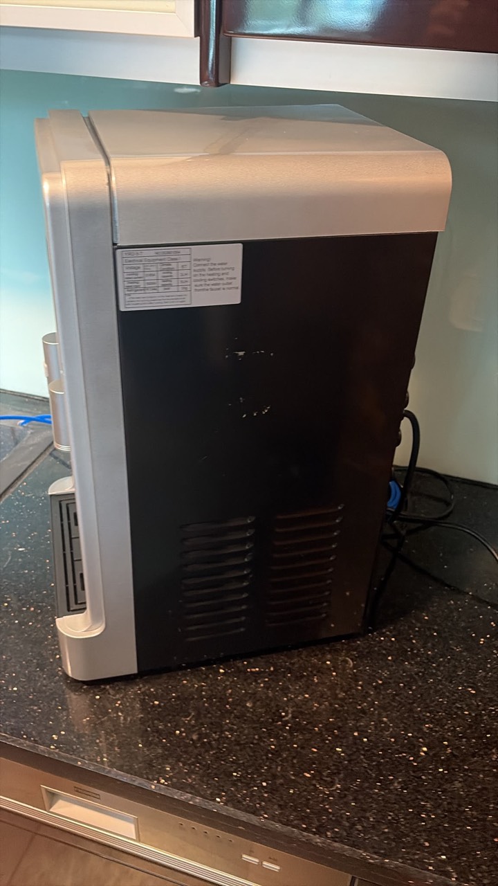 Side of the unit: rating label and chipped black panel